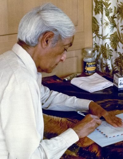 Krishnamurti at the desk writing a letter