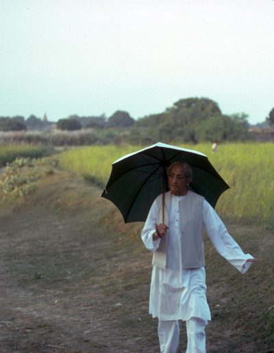 Krishnamurti walking with a parasol