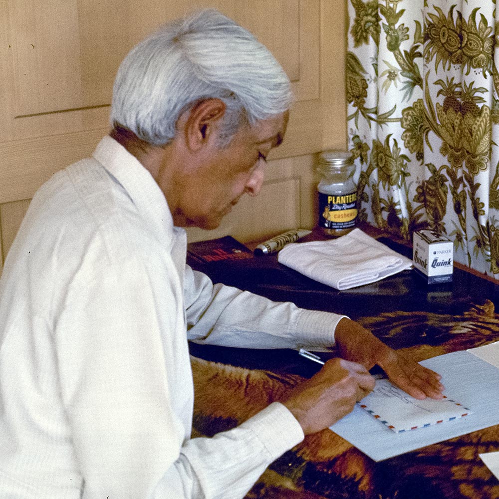 Krishnamurti at the desk writing a letter