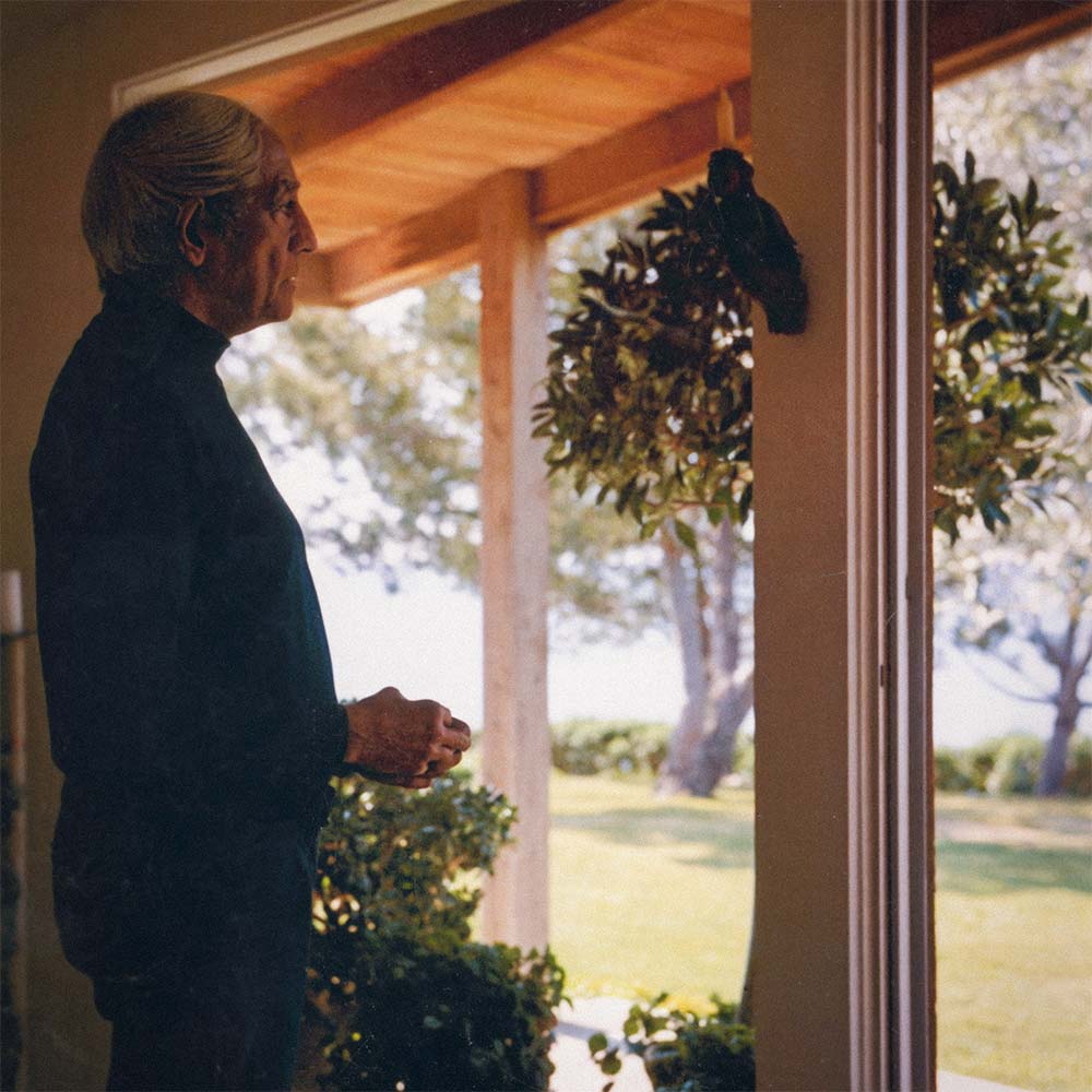 Krishnamurti smiling at the camera